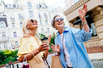 Portrait of female friends standing in city