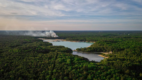 Aerial shot of one of the blue holes near manumuskin river with a fire burning near it