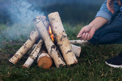 Low section of man relaxing on field