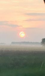 Scenic view of field against sky during sunset