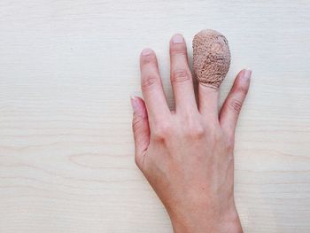 Close-up of hand on table