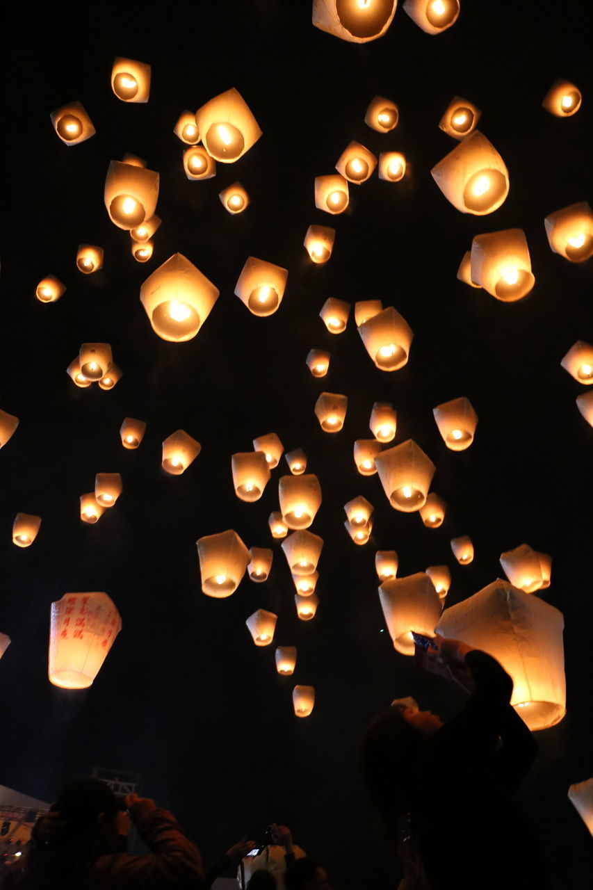 illuminated, celebration, flame, lighting equipment, heat - temperature, burning, glowing, night, candle, large group of objects, low angle view, lantern, traditional festival, indoors, no people, black background, sky