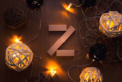 Directly above shot of letter z blocks and illuminated lights on wooden table