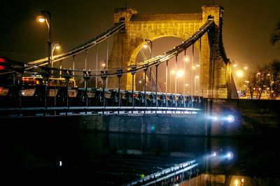 Grunwaldzki bridge over river oder against sky in city at night