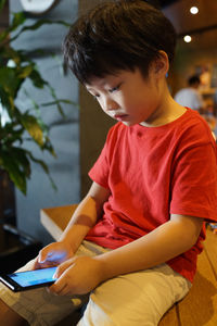 Boy using smart phone at home
