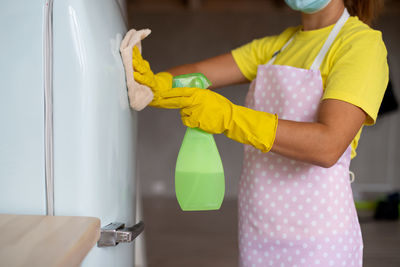 Midsection of woman standing at home