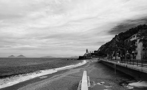 Road by city against sky