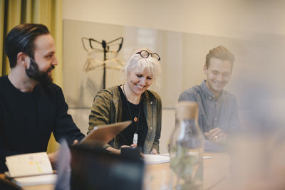 Happy colleagues working together in board room