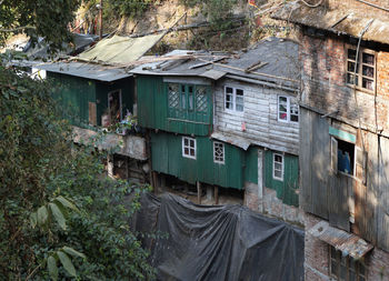 Old abandoned house amidst trees and plants