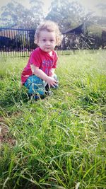 Girl smiling while standing on grass