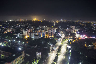 High angle view of illuminated city buildings at night