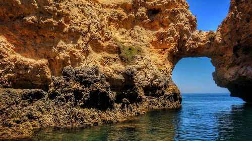 Scenic view of sea seen through cave