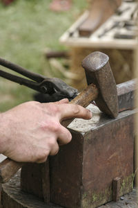 Cropped image of blacksmith using hammer