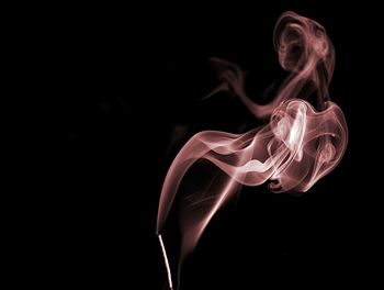 Close-up of smoke over black background