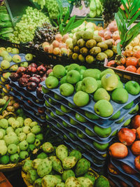 Green fruits for sale in market stall