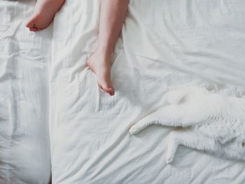 Low section of man relaxing on bed