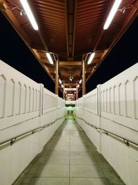 Illumianted walkway at railroad station platform during night