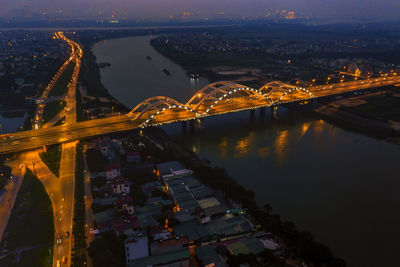 High angle view of illuminated bridge over river at night