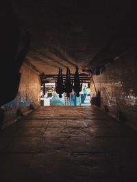 People in illuminated tunnel