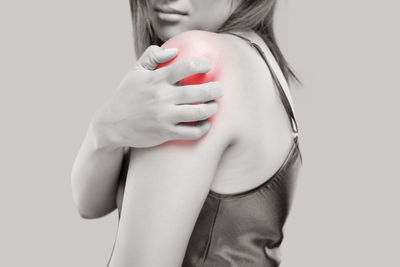 Close-up of woman with hand on white background