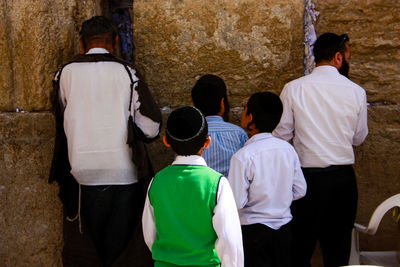 Rear view of people standing in temple