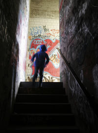 Full length of woman walking on steps