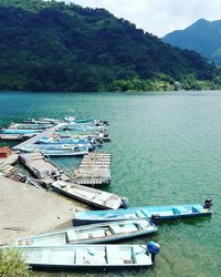 High angle view of boats moored in lake against sky