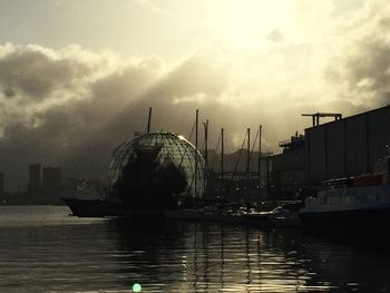 Boats in river with city in background