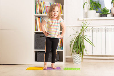 The child trains at home fitness, yoga, exercises.  physical and mental health trend