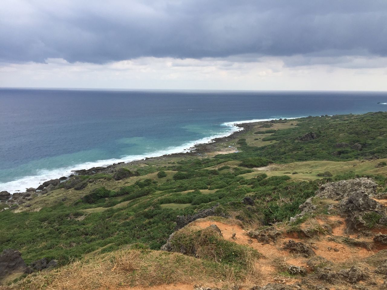 sea, horizon over water, sky, water, tranquil scene, scenics, tranquility, beauty in nature, beach, cloud - sky, nature, shore, coastline, grass, cloudy, cloud, idyllic, day, remote, non-urban scene