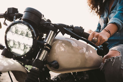 Midsection of woman riding motorcycle