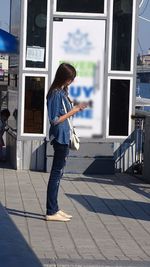 Young woman standing in front of steps