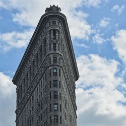 Low angle view of flatiron building against sky in city