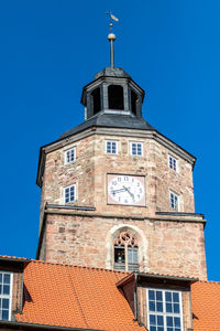 Low angle view of building against clear blue sky