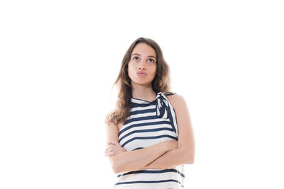 Portrait of beautiful young woman standing against white background