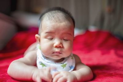 Cute baby girl sleeping on bed