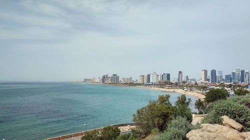 Scenic view of sea and buildings against sky