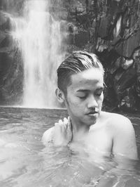 Portrait of young man in water