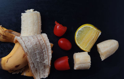 High angle view of fruits on table against black background