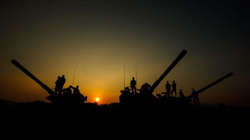 Rear view of man standing against sky during sunset