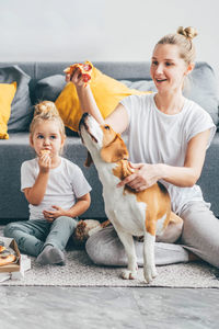 Portrait of happy family sitting on sofa at home