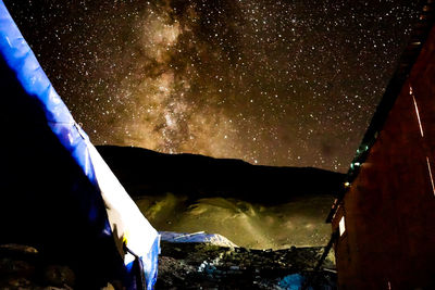 Low angle view of illuminated mountain against sky at night