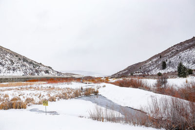 Scenic view of snow covered mountains against sky