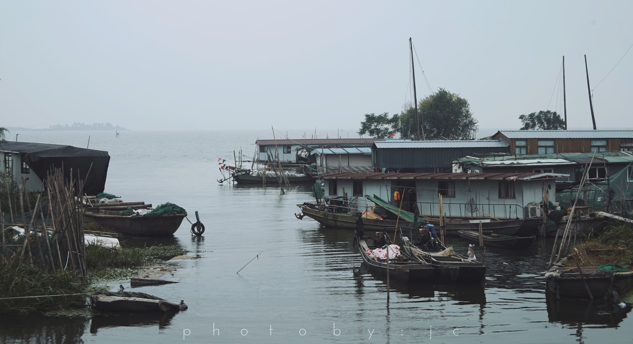 BOATS MOORED IN HARBOR