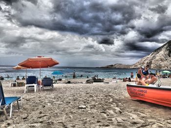 People on beach against sky