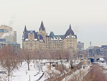 Buildings in city against clear sky