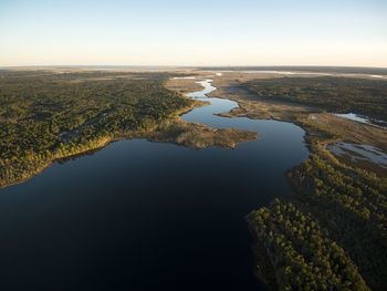 Aerial view of river amidst landscape against clear sky