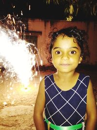 Portrait of smiling girl standing outdoors at night