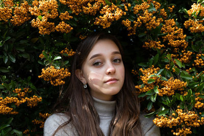 Portrait of woman with red flowers