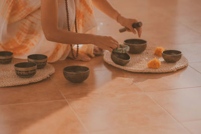 Female hands play meditation on tibetan bowls